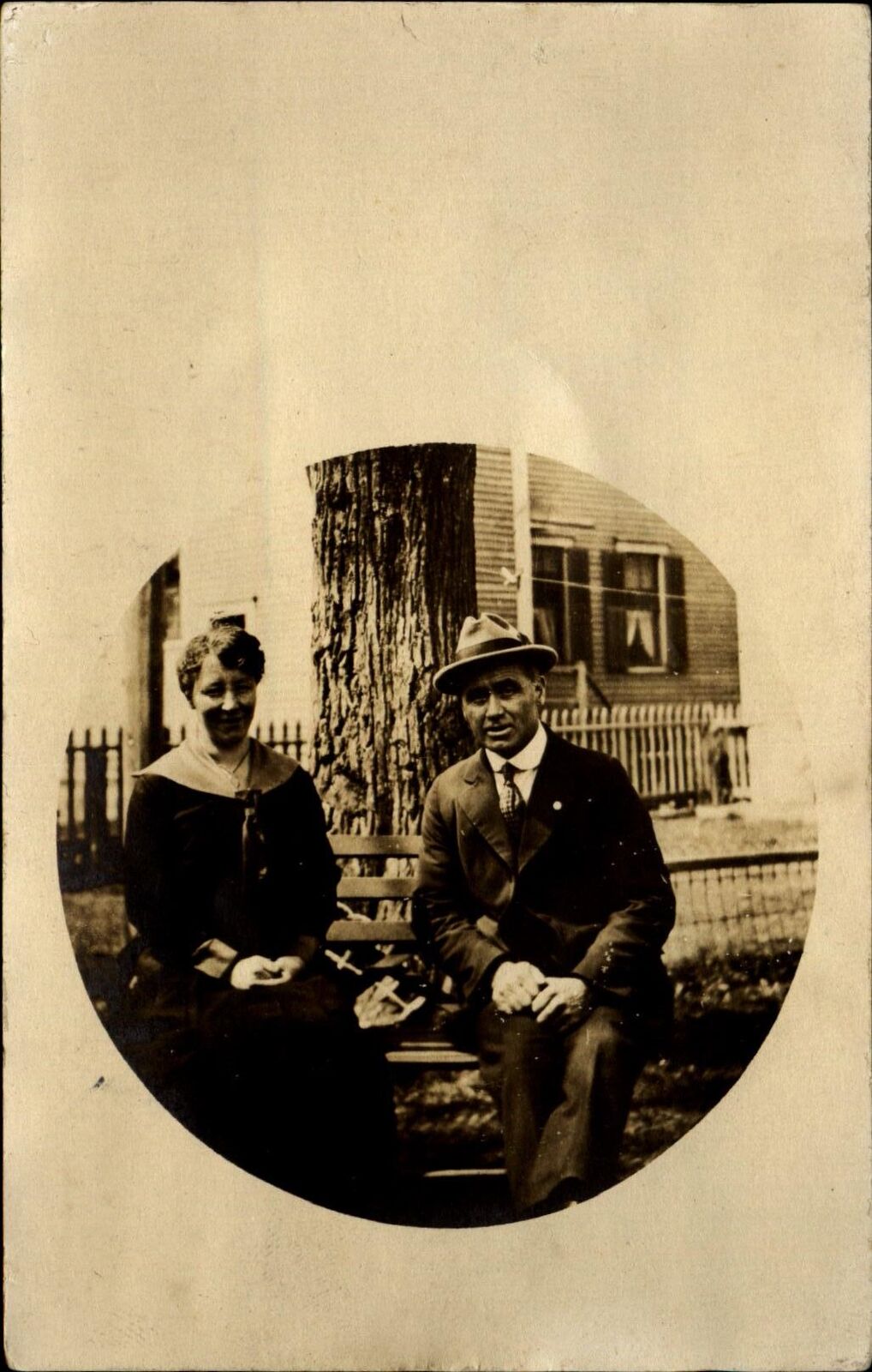RPPC~couple sitting together on bench~possibly New Bedford Massachusetts ~ c1910
