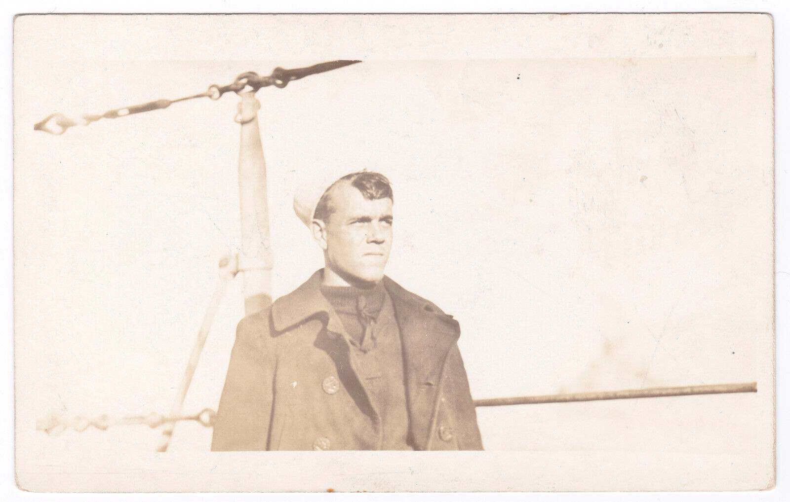 WW1 WWI Era Sailor Overcoat Hat Stern Looking On Deck Steel Cables RPPC Postcard