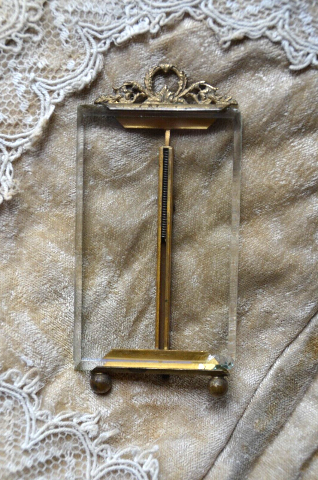 Antique French bronze photograph holder, bevelled glass, ornate scrolled top