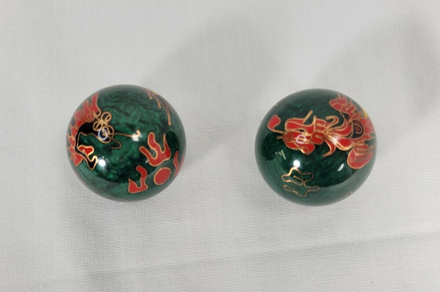 Pair of vintage green Chiming Baoding Balls with Dragon and Phoenix