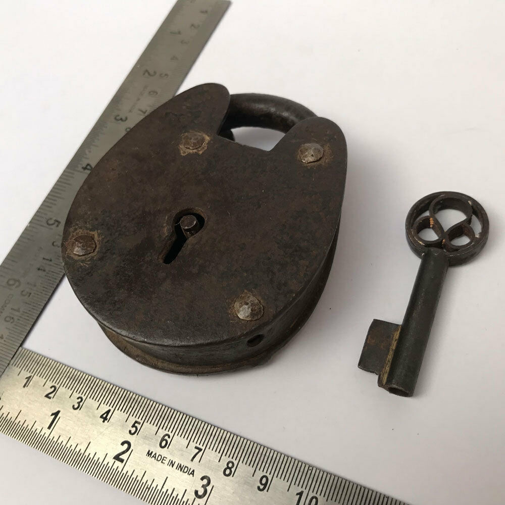An old or antique iron padlock lock with key decorative oval shape.