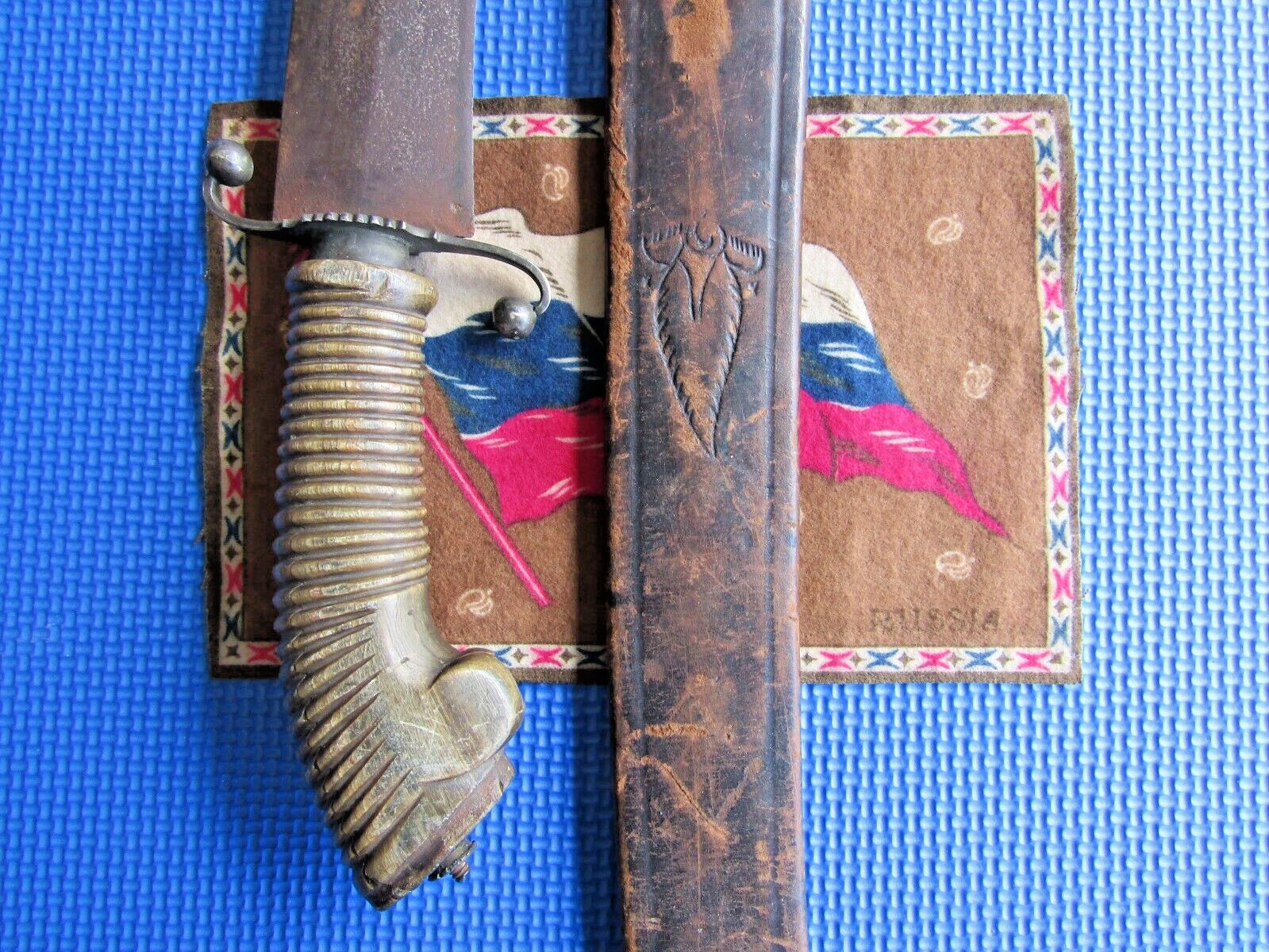 antique pioneer short sword with worn scabbard.