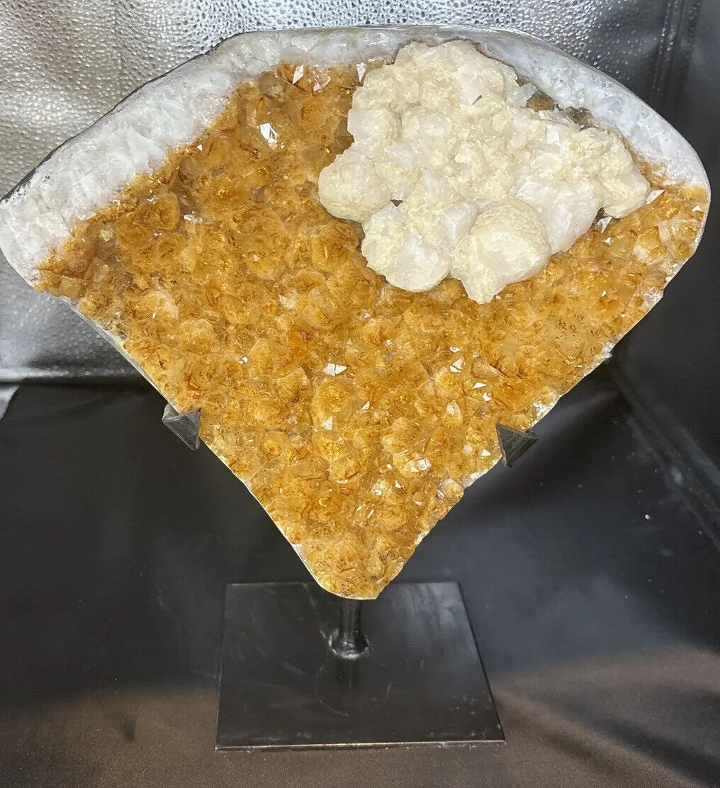 A grade citrine cluster with calcite on a stand