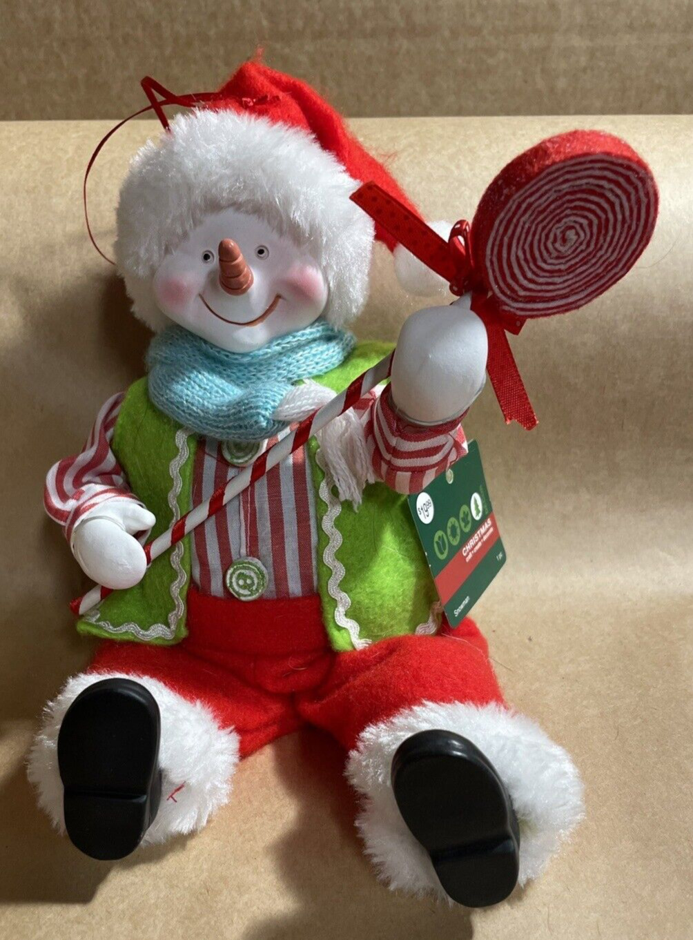 Christmas Ornament - Sitting Snowman ceramic head hands holding lollipop 