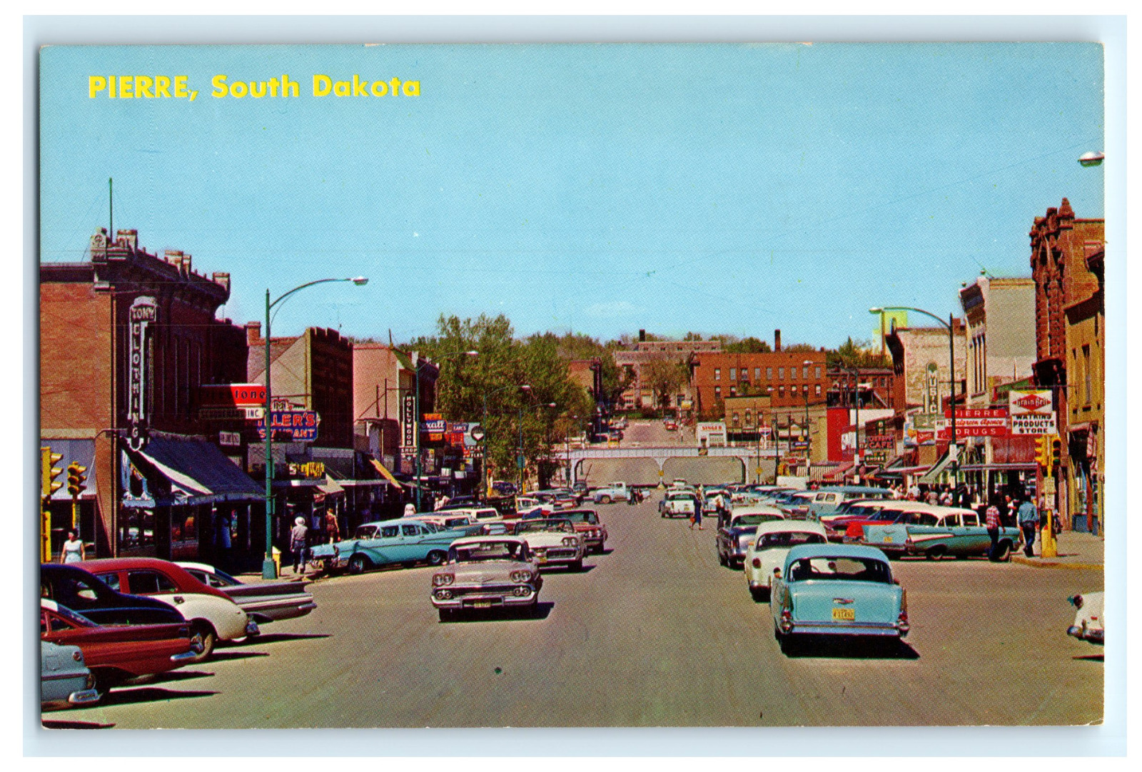 Postcard SD Pierre Busy Main Street View 1950's Cars Storefronts Signs Rexall