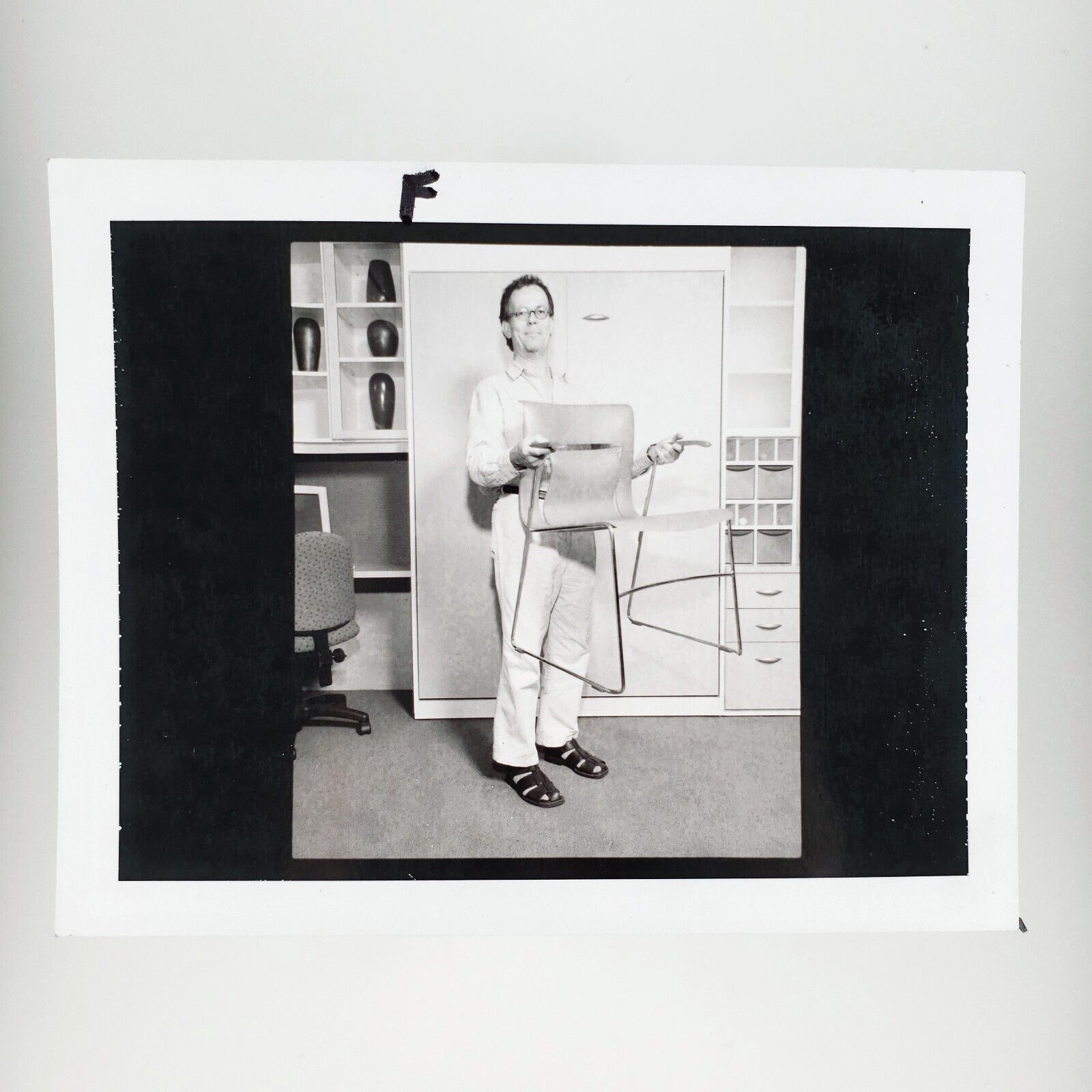 Office Worker Holding Chair Photo 1990s Vintage Strange Candid Man Shelves D1927