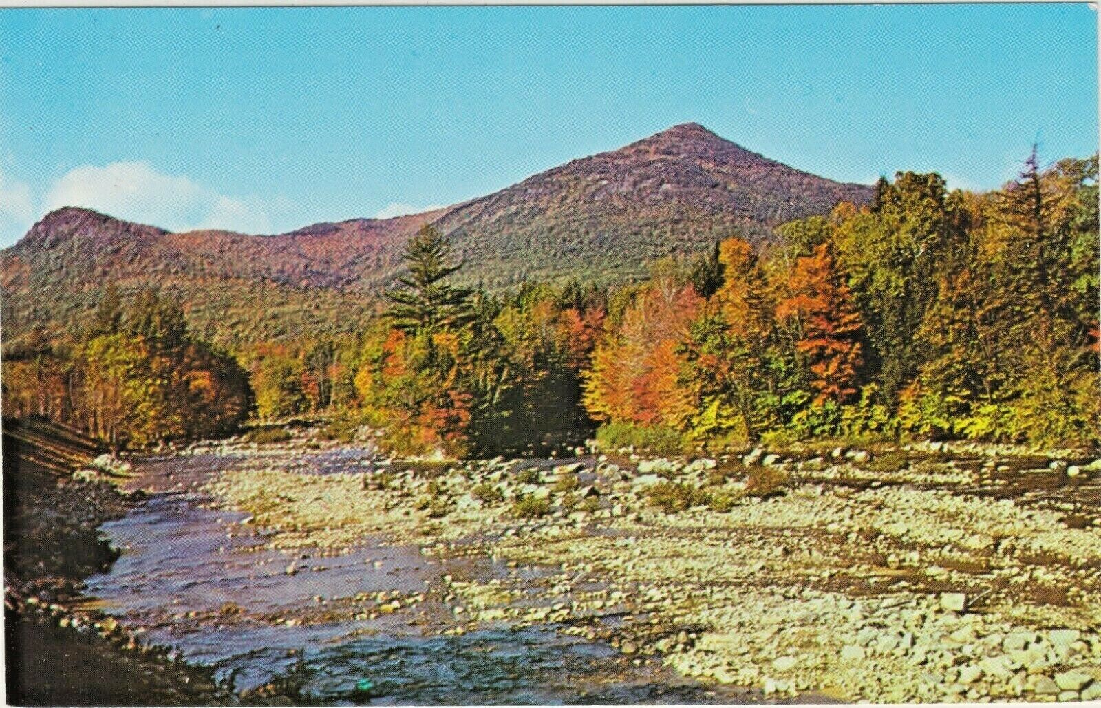 A Typical New England Fall Scene along a Stream with Trees with Colorful Leaves