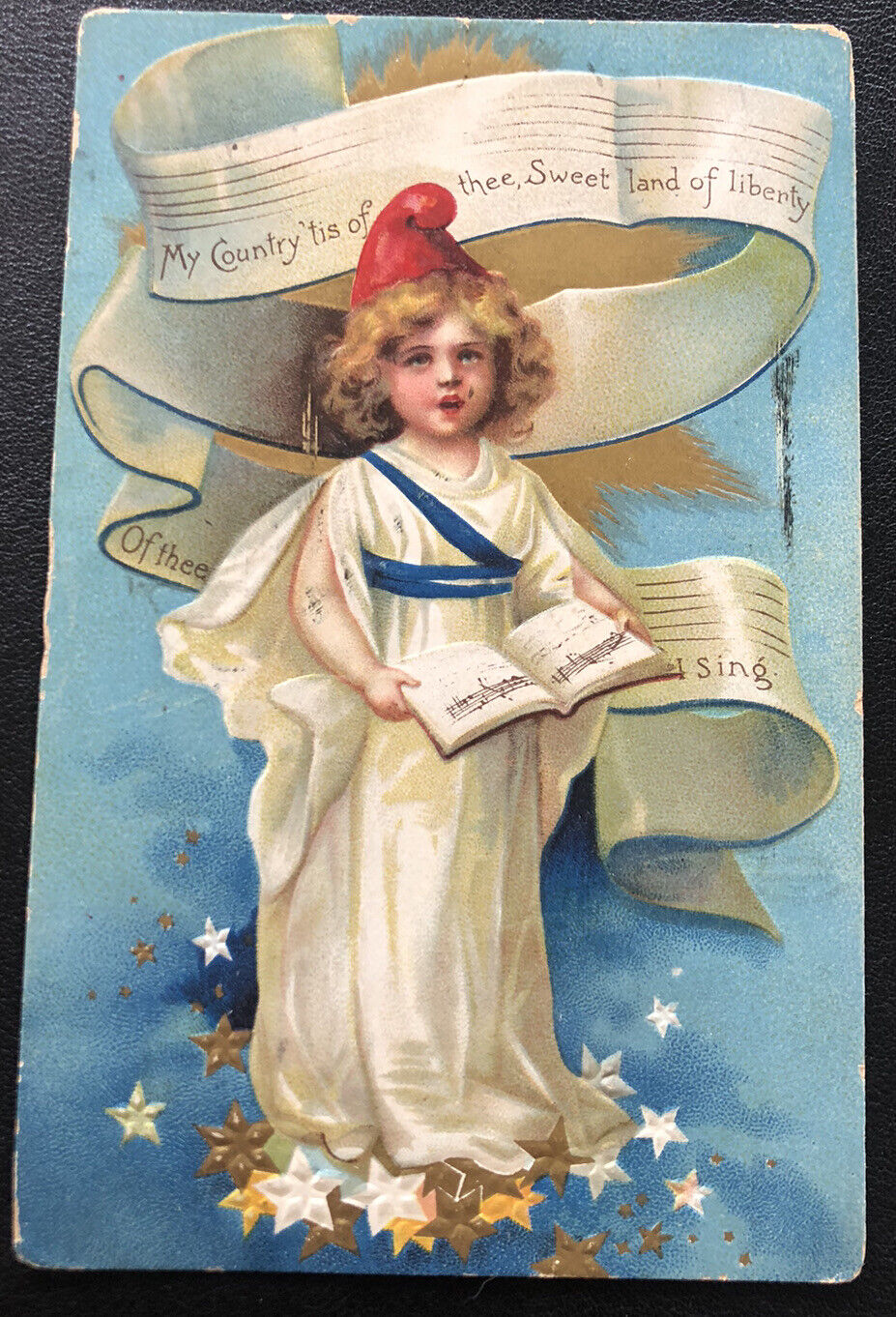 Liberty girl in white white gold stars song US Patriotic Vintage Postcard G11