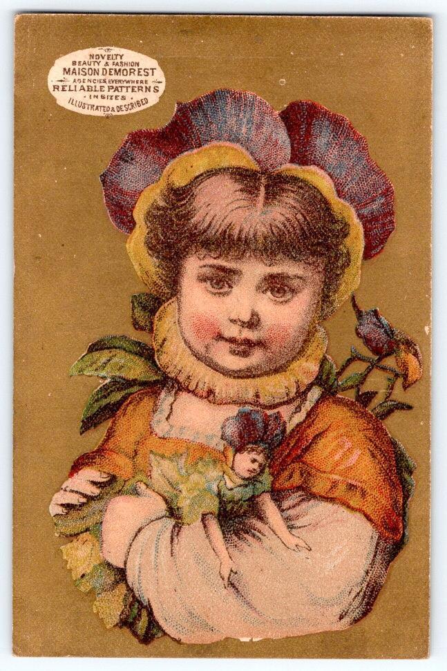MAISON DEMOREST RELIABLE PATTERNS PANSY FLOWER HEAD GIRL WITH DOLL TRADE CARD