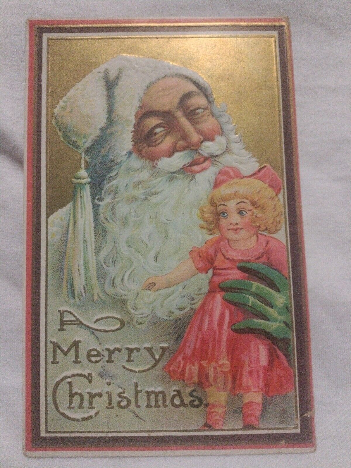 Christmas Postcard White Suited Santa Claus with Green Glove Holding Pink Doll