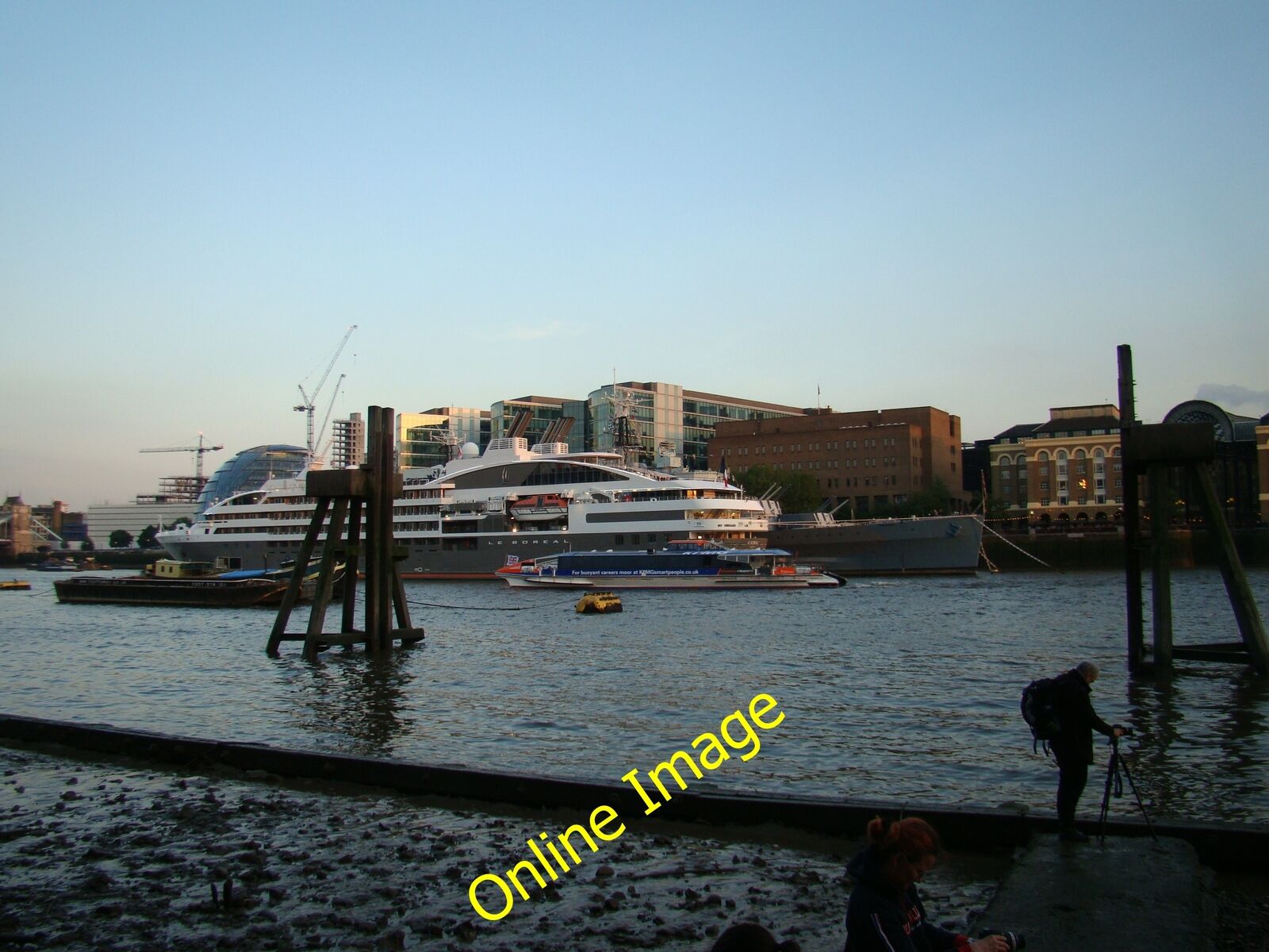 Photo 6x4 View of a Thames Clipper passing Le Boreal and HMS Belfast Lond c2014