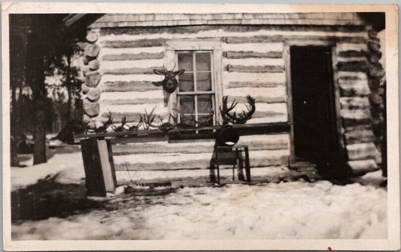 RPPC Photo Postcard HUNTING LOG CABIN Winter Scene / Deer Head & Antlers c1930s