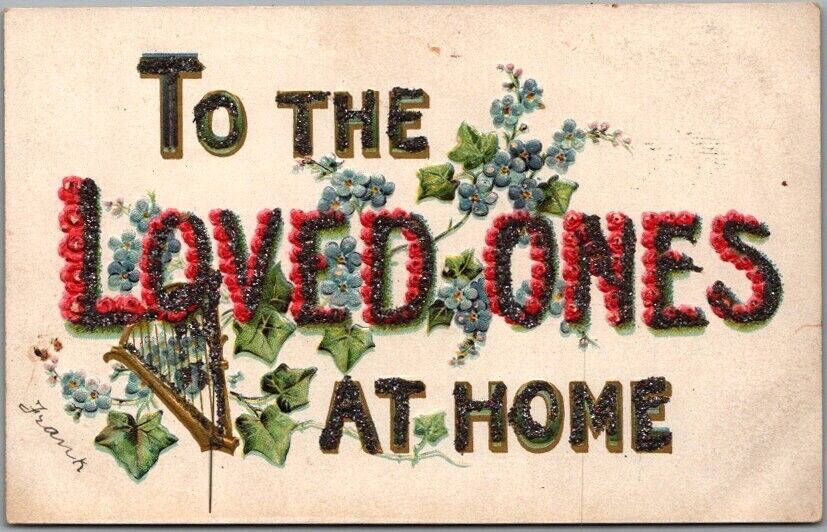 1910s Large Letter Embossed Postcard TO THE LOVED ONES AT HOME Glitter / Flowers