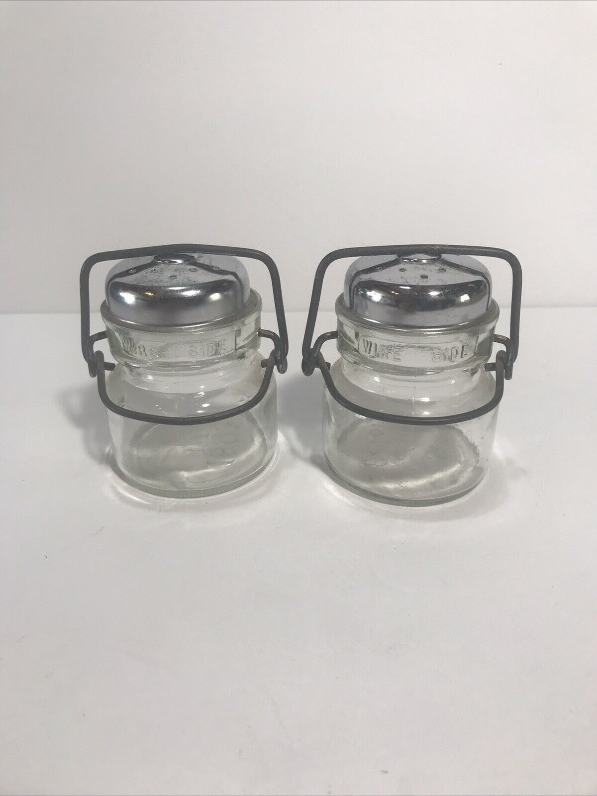 Vintage 1893 FP Bail Wire Lid Clear Glass Salt and Pepper Shaker Set 3.5”