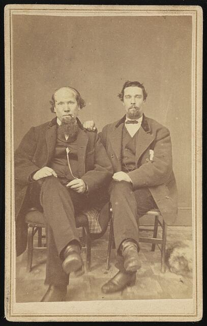 Photo:Two unidentified men, seated, facing front