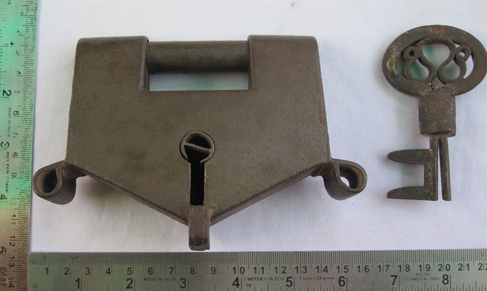 An old or antique Iron lock or padlock with original key unusual key-hole