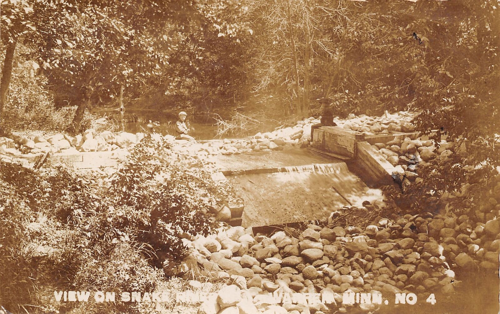 Warren Minnesota~Boy Sits Above Spillover Rock Pile on Snake River RPPC 1909