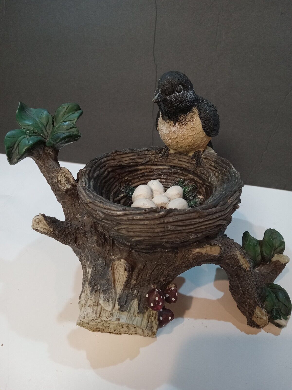 Bird in nest with eggs in tree, made of resin