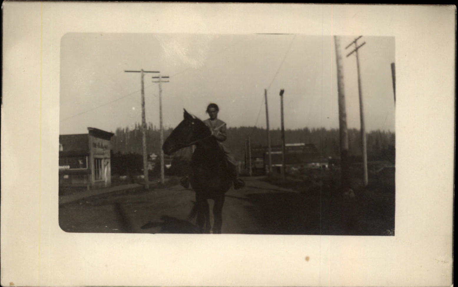 RPPC Woman on horse unknown town partial Peerless Tobacco sign 1904-20s postcard