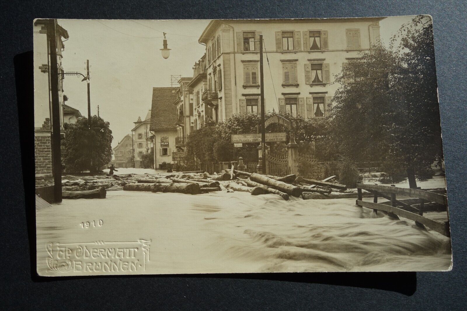 1910 flooded European town logs floating through streets real photo postcard