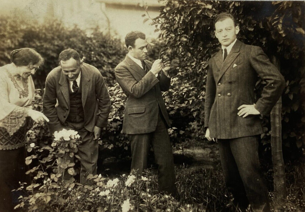 Handsome Man Posing While Others Look At Plants B&W Photograph 3 x 4.25