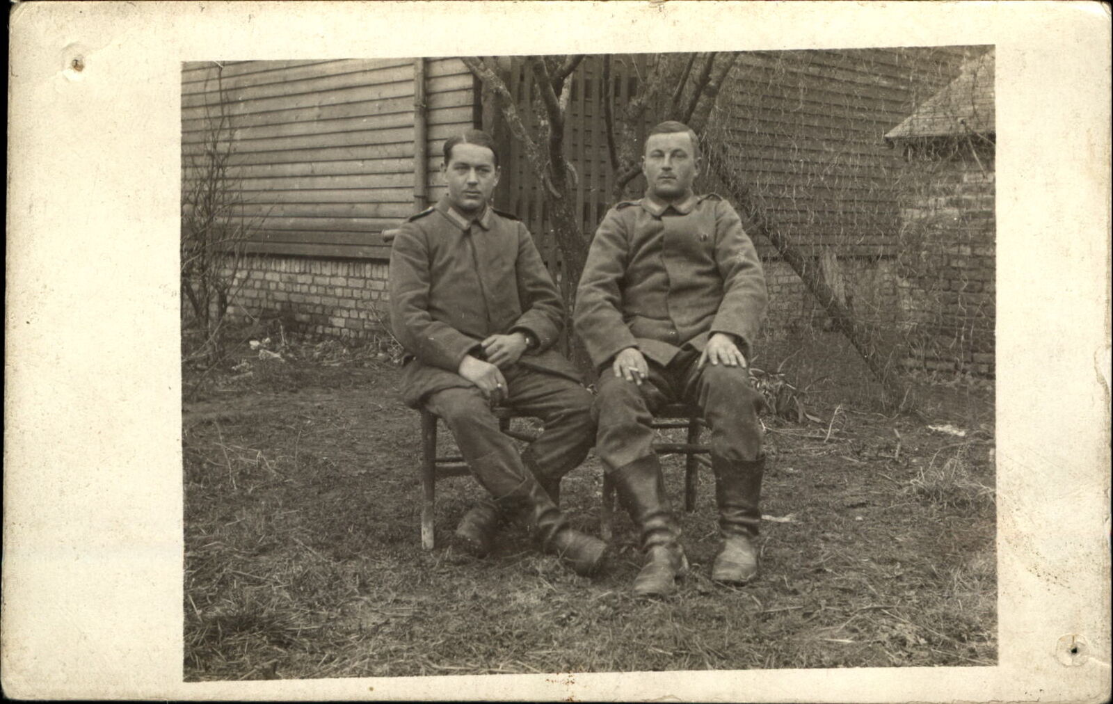 WWI German soldiers uniform sitting outside ~date on back 1918 ~ RPPC real photo