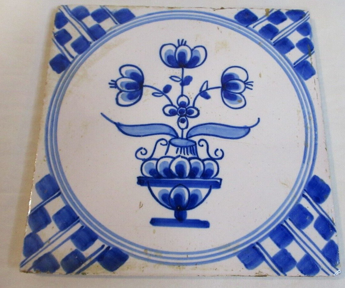 ANTIQUE DELFT (HB) TIN GLAZED TILE WITH GEOMETRIC CORNERS AND A VASE OF FLOWERS