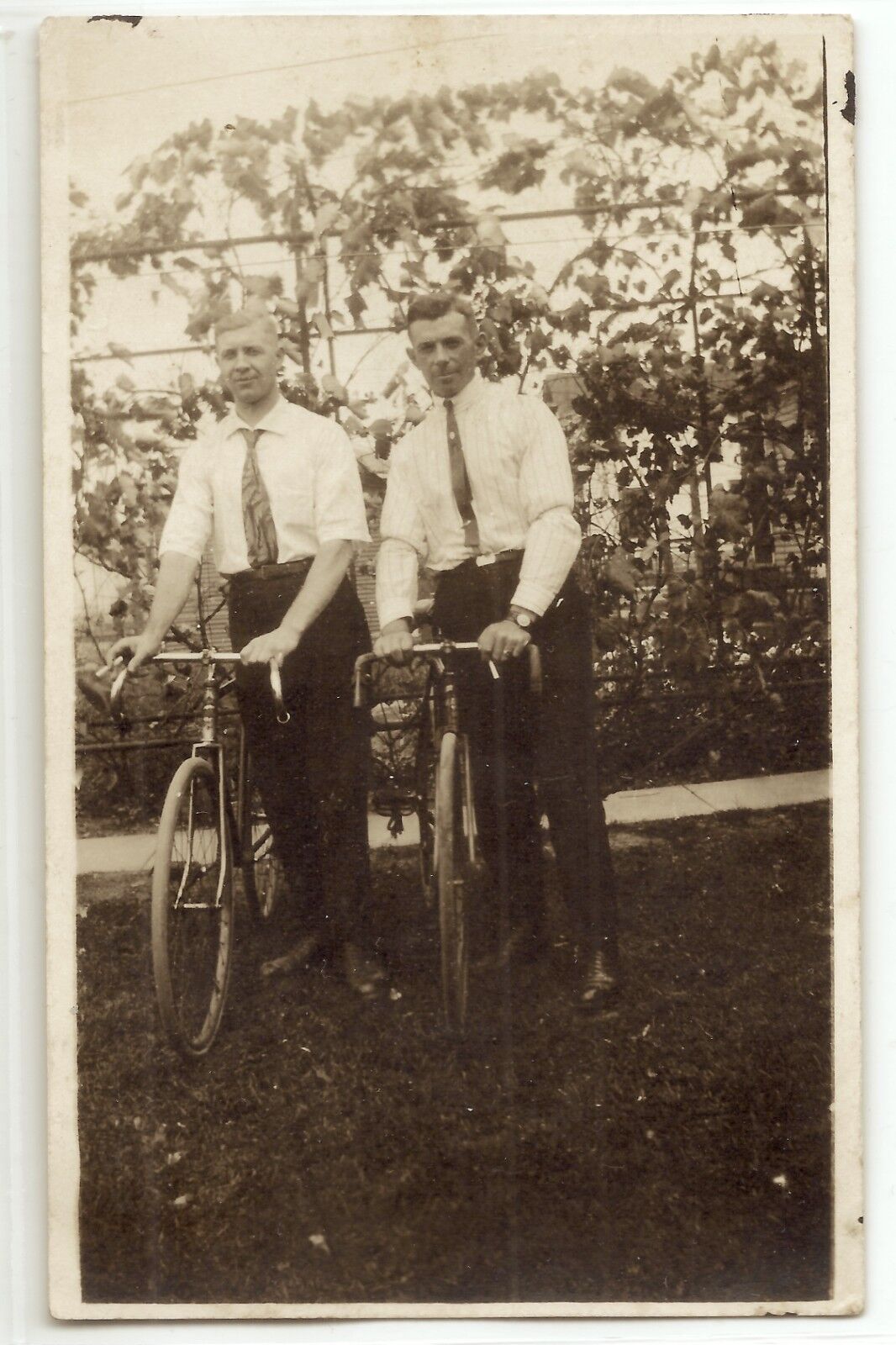 Two men with early bicycles, c. 1905, bikes, real photo postcard RPPC, old