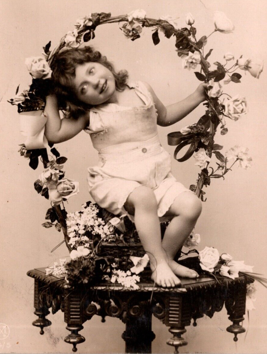 c1908 RPPC Studio Photo Postcard: Adorable Kid Sits In A Floral Designed Basket