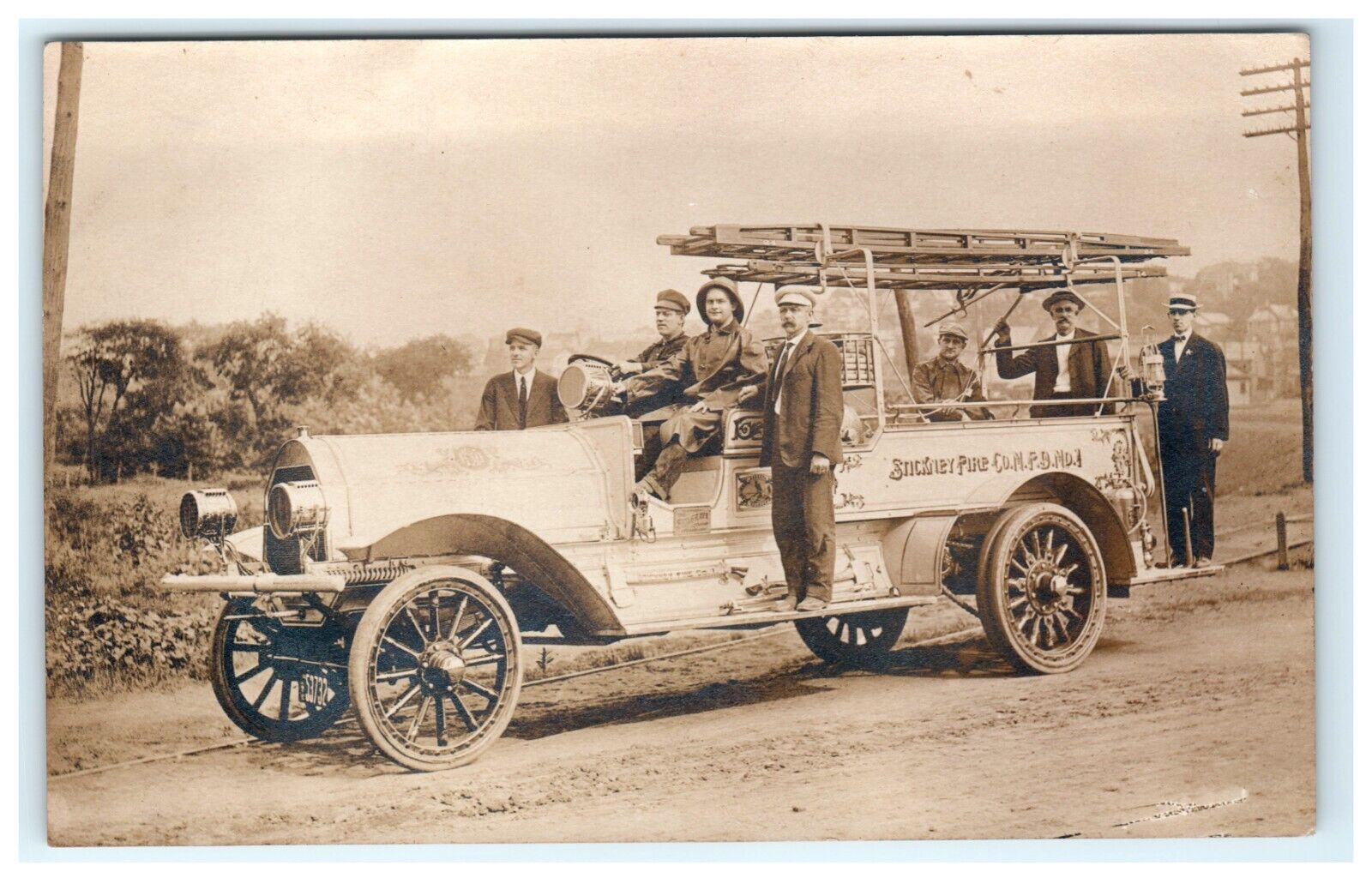 1912 Nanticoke PA Stickney Co. Fire Company Truck Dirt Street Men Uniform RPPC