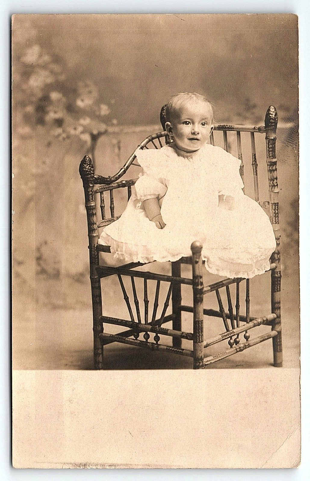 c1910 VERY CUTE BABY GIRL IN UNIQUE CHAIR STUDIO PHOTOGRAPH RPPC POSTCARD P4272