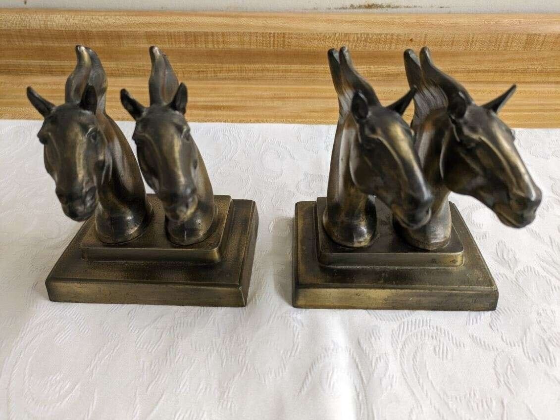 Vtg. double horse head metal bookends pair.