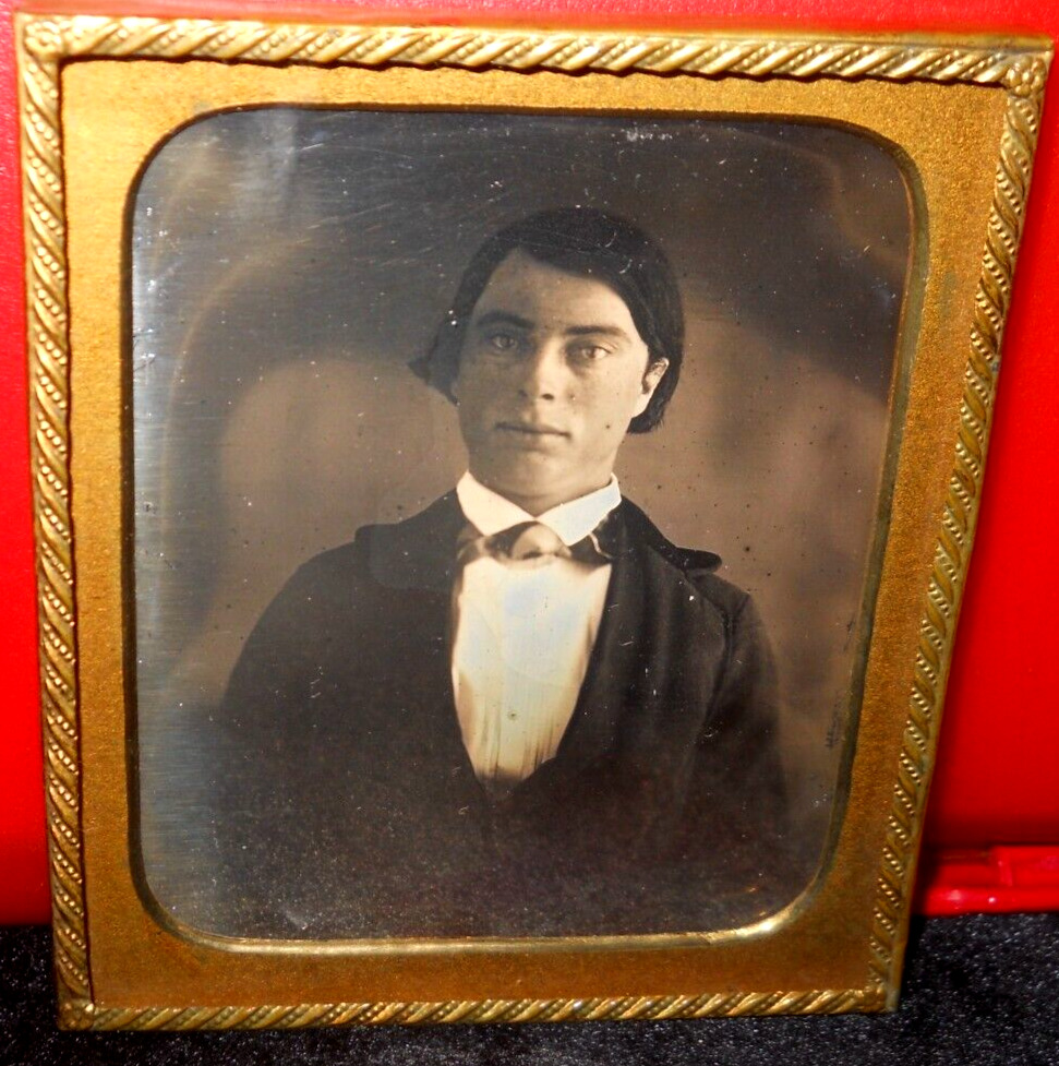 1/6th Size Daguerreotype of young man in brass mat/frame
