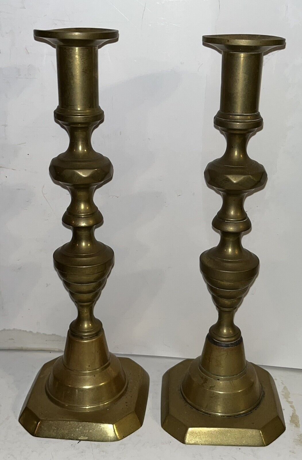 Pair of Antique Spun Brass Queen Anne Push-up Candle Sticks