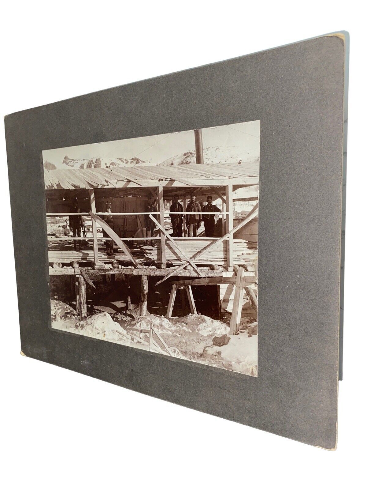Early logging yard photograph with lumber and workers