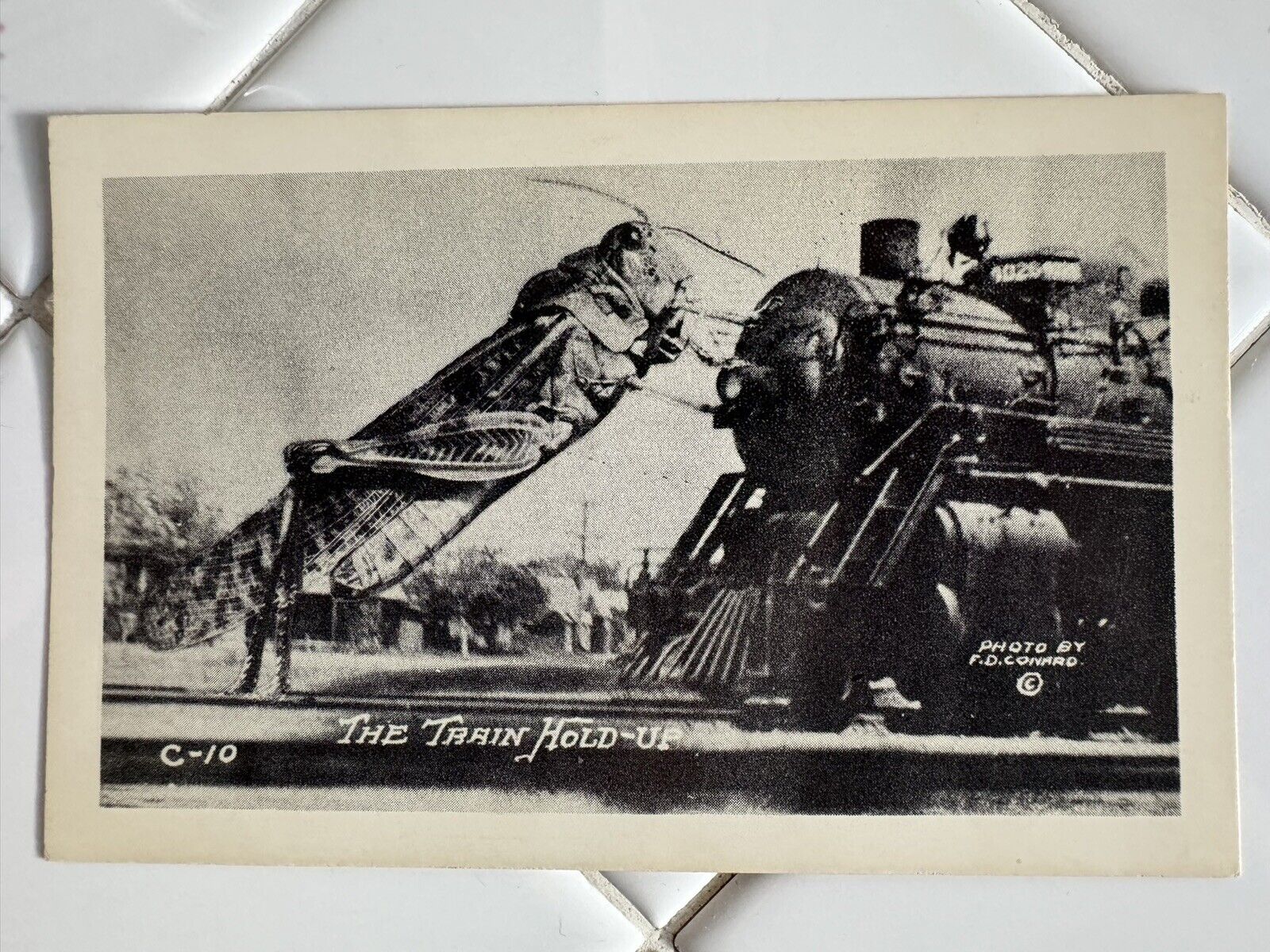 c1930’s F.D. Conrad Exaggerated Grasshopper Train Hold Up RPPC Photo Postcard