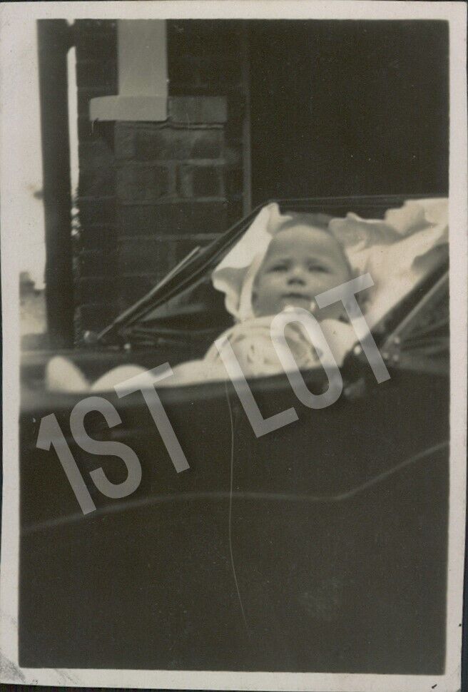 Vintage Photograph of a Young Baby Outside in an Old Vintage Pram