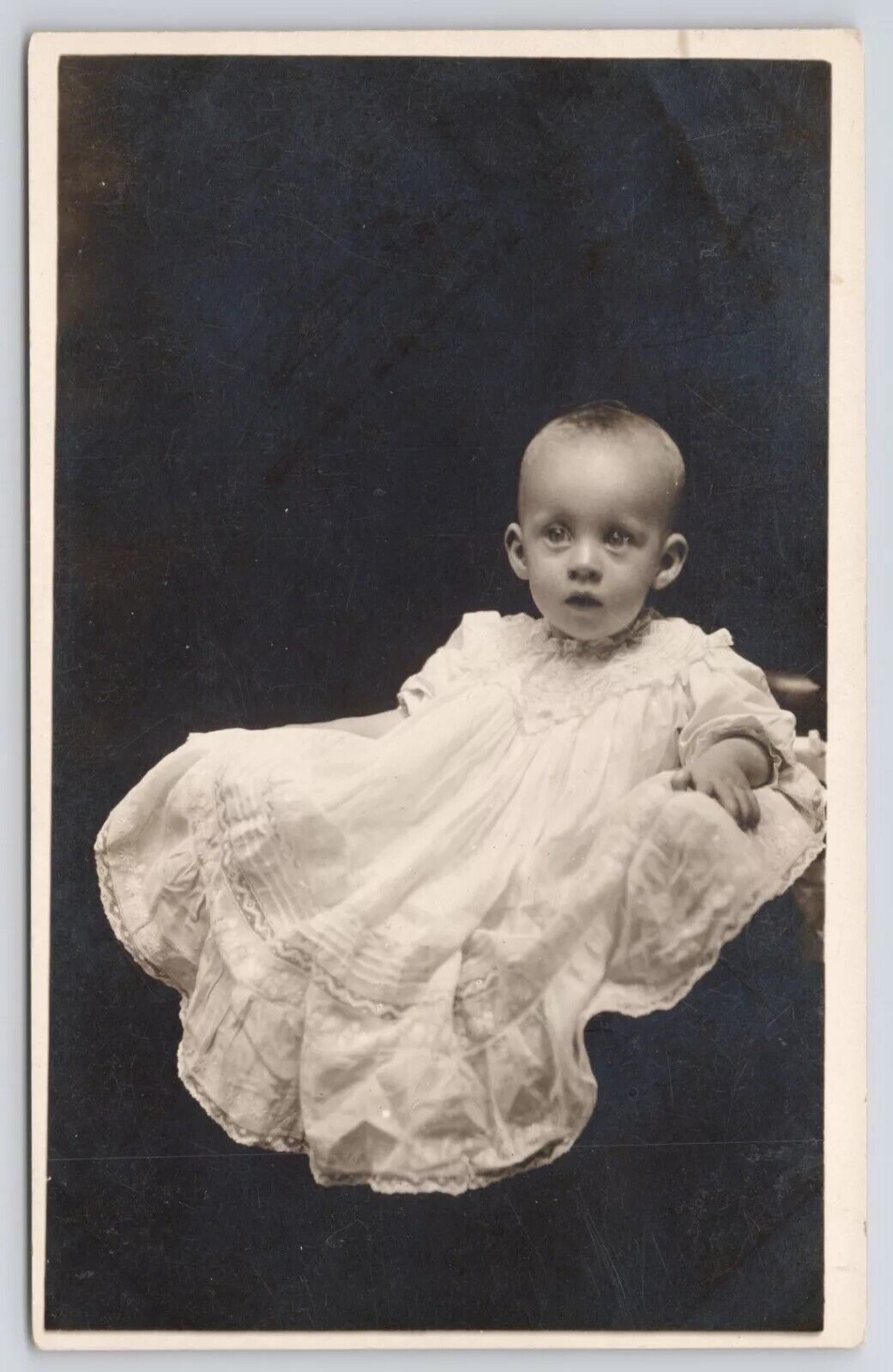 RPPC Wide-Eyed Blonde Haired Baby in Studio c1910 Real Photo Postcard