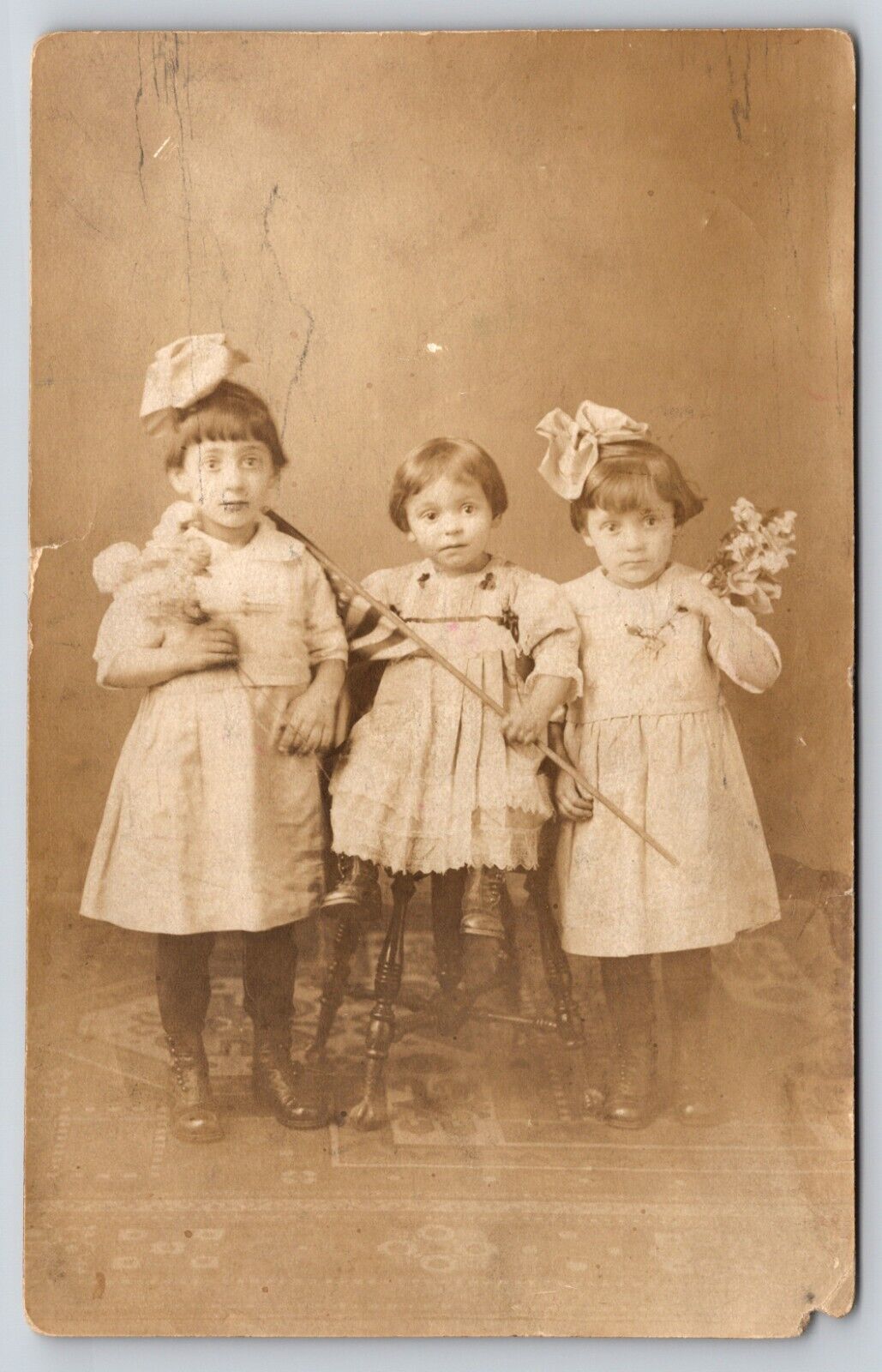 Postcard RPPC Girls with American Flag and Flowers Real Photo Wide Eyed Sisters
