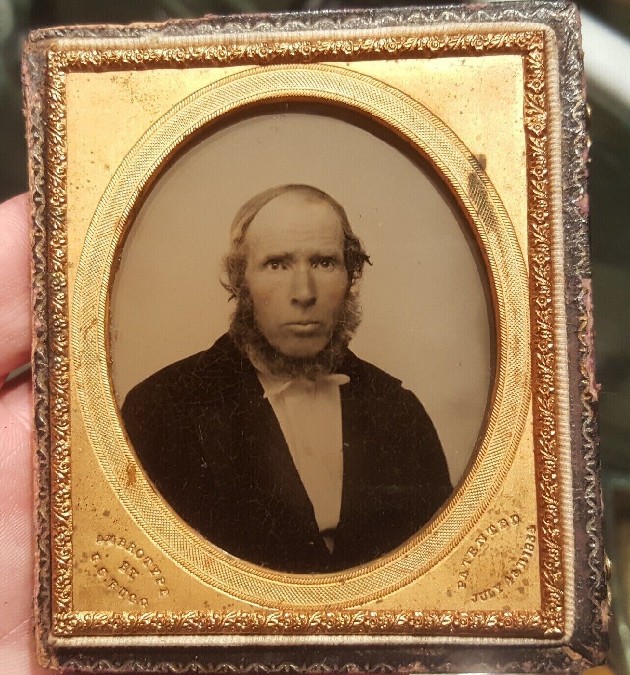 Sixth plate ambrotype of bald man signed on mat by G. S. Rugg