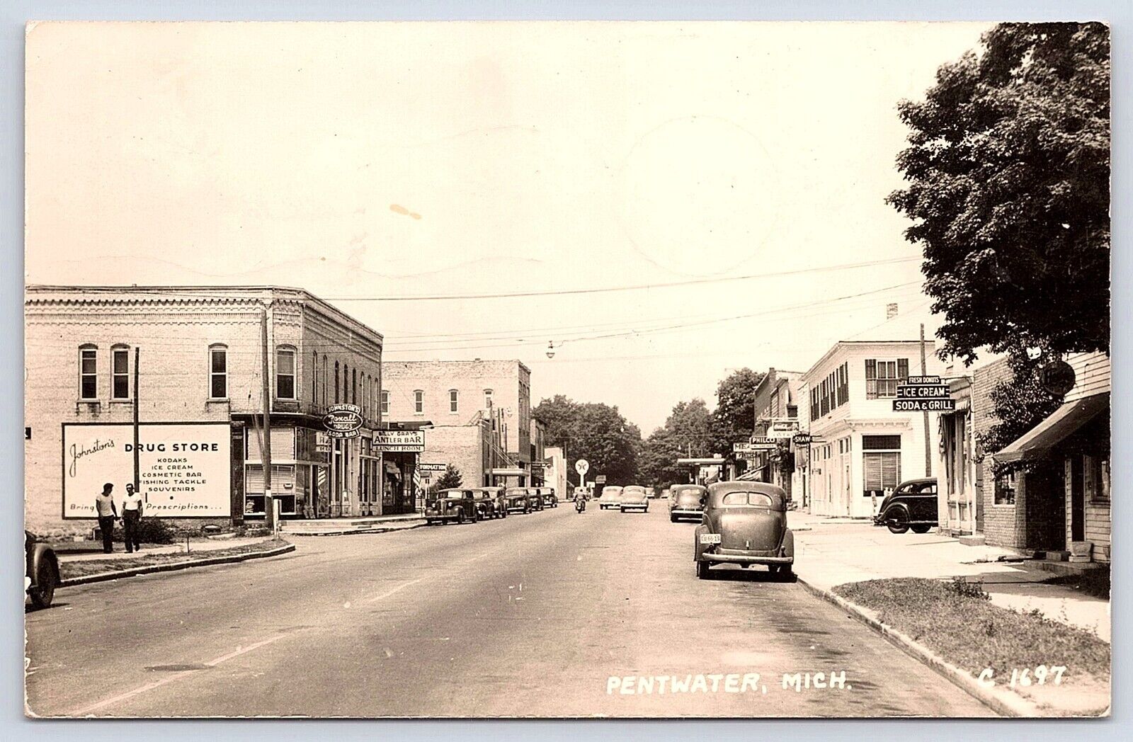 Postcard RPPC Pentwater MI Main Street Rexall Drug Antler Bar Cars Posted 1949