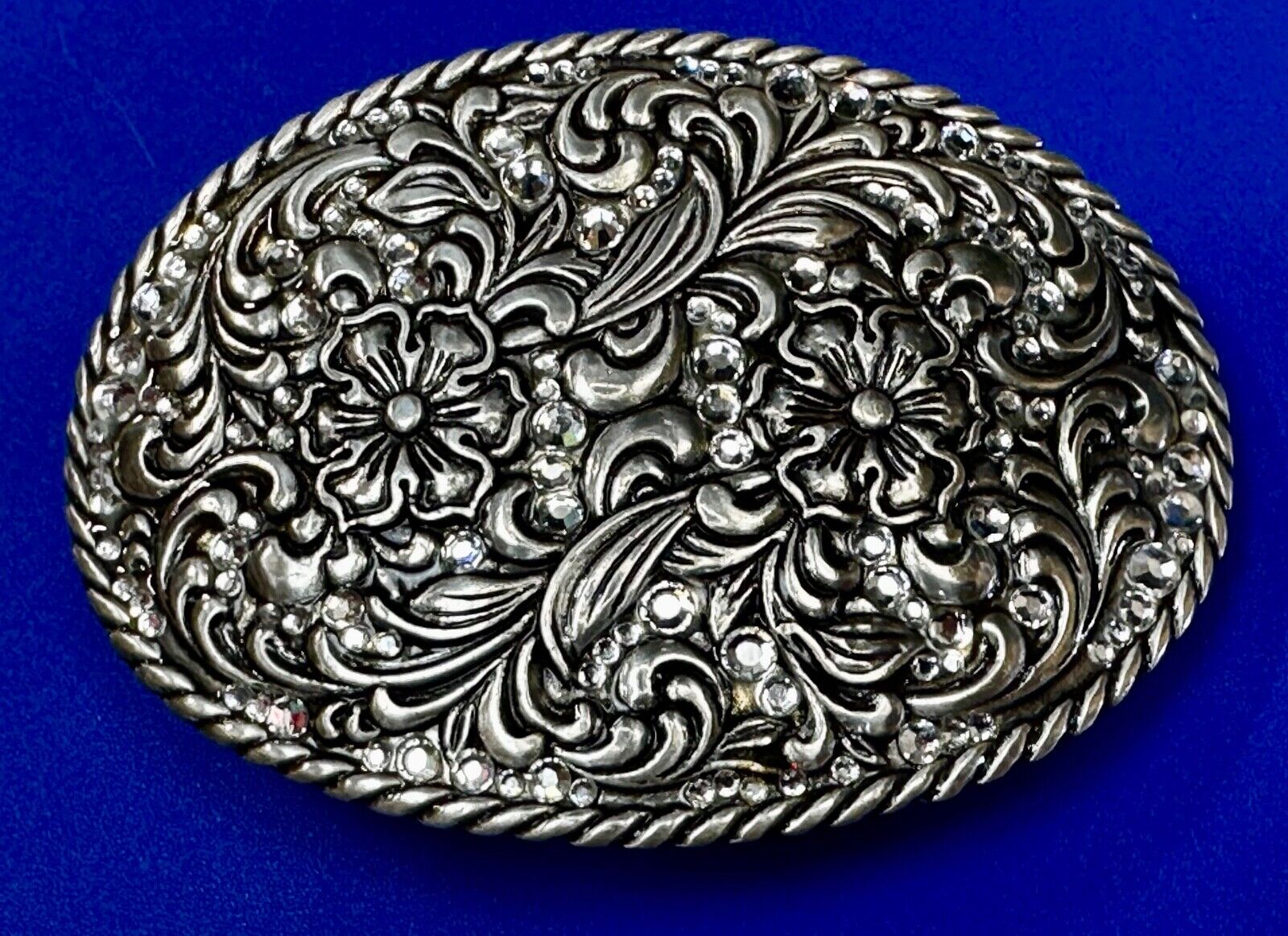 Rhinestone covered western silver tone oval floral Belt Buckle by Nocona