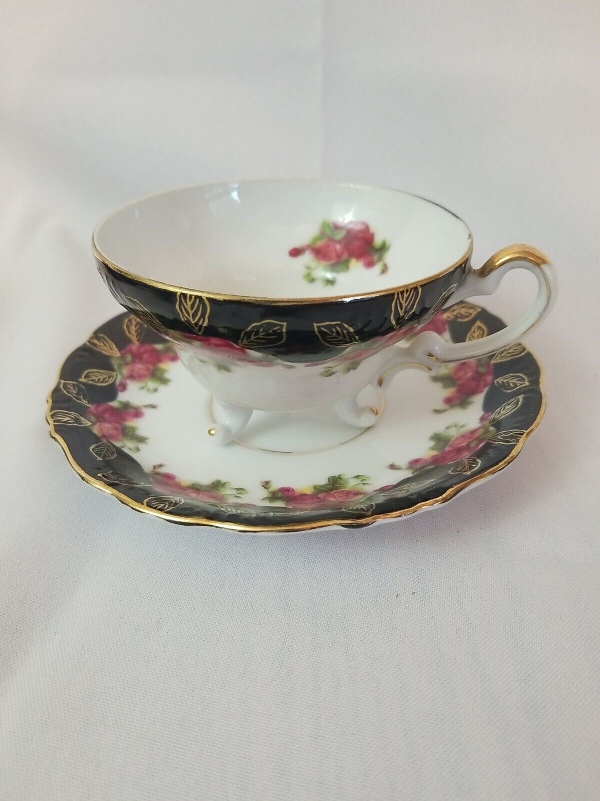 Vintage MARCO Tea cup and saucer. Footed. Gold Gilding, black with red roses
