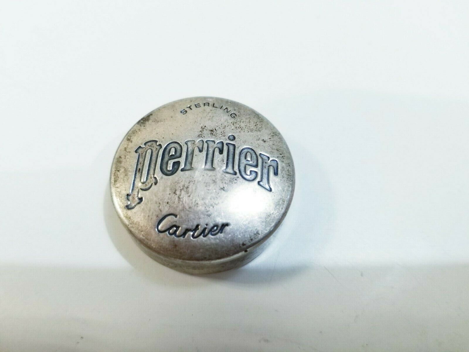 MATCHING PAIR OF CARTIER STERLING SILVER BOTTLE CAPS