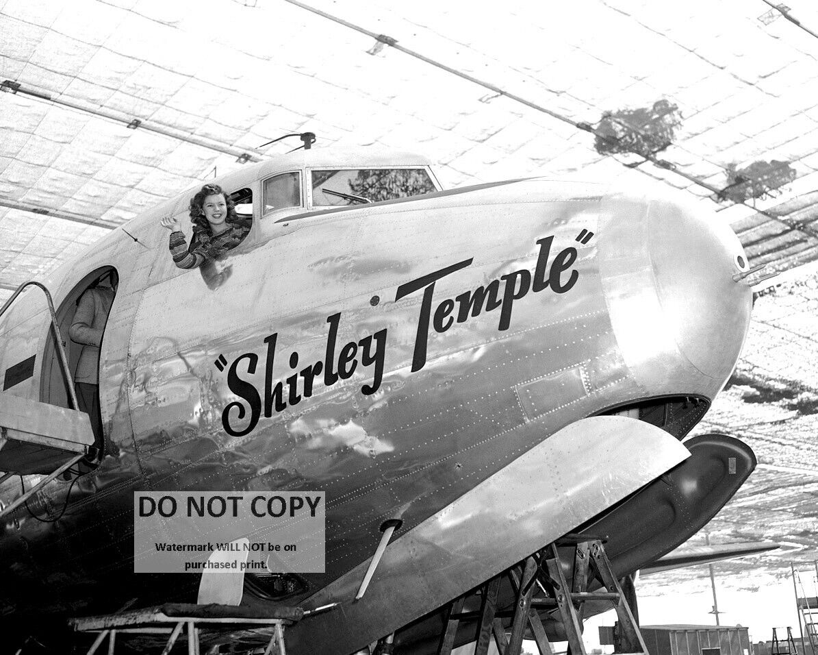 SHIRLEY TEMPLE LEANS OUT OF COCKPIT OF NAMESAKE AIRCRAFT - 8X10 PHOTO (RT397)