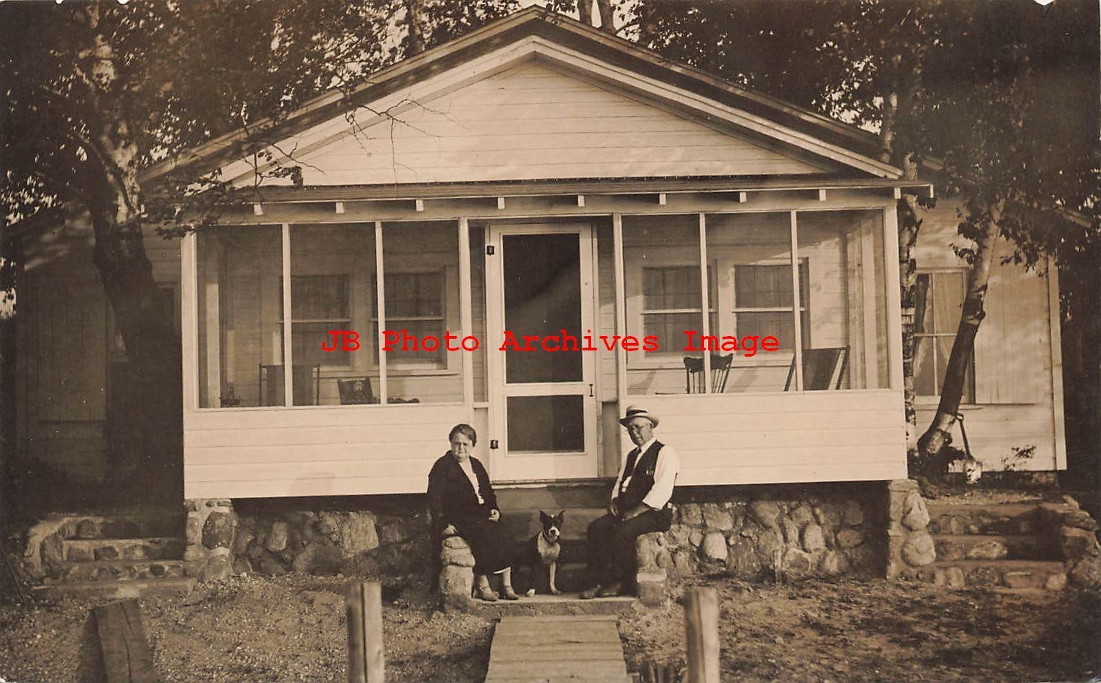 Unknown Location, RPPC, Couple with Dog sitting at their Cottage Home