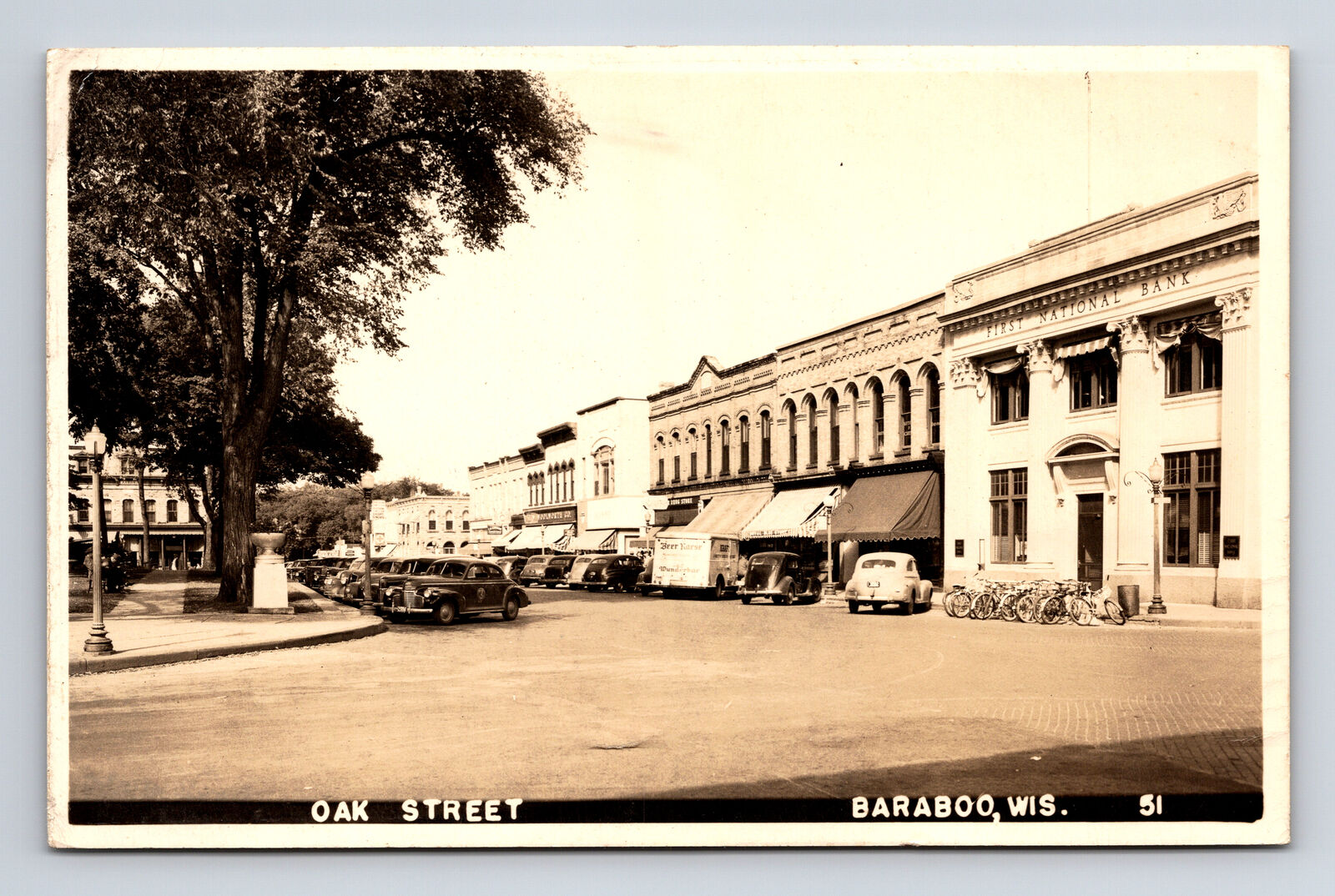 1947 RPPC Oak Street Town Square Cars Bicycles Bank Baraboo WI Postcard