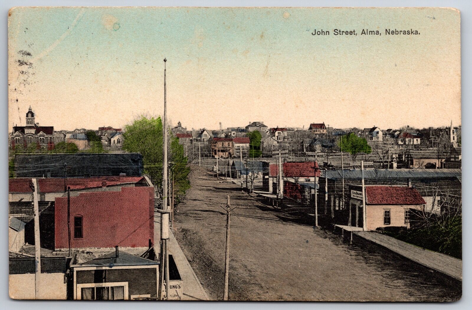 Alma Nebraska~John Street~Young\'s Jewelry~Homes~Windvanes~1910 Handcolored PC