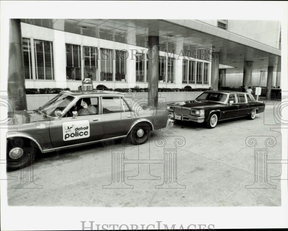 1985 Press Photo A cop guards Mayor\'s auto at City County Building in Detroit