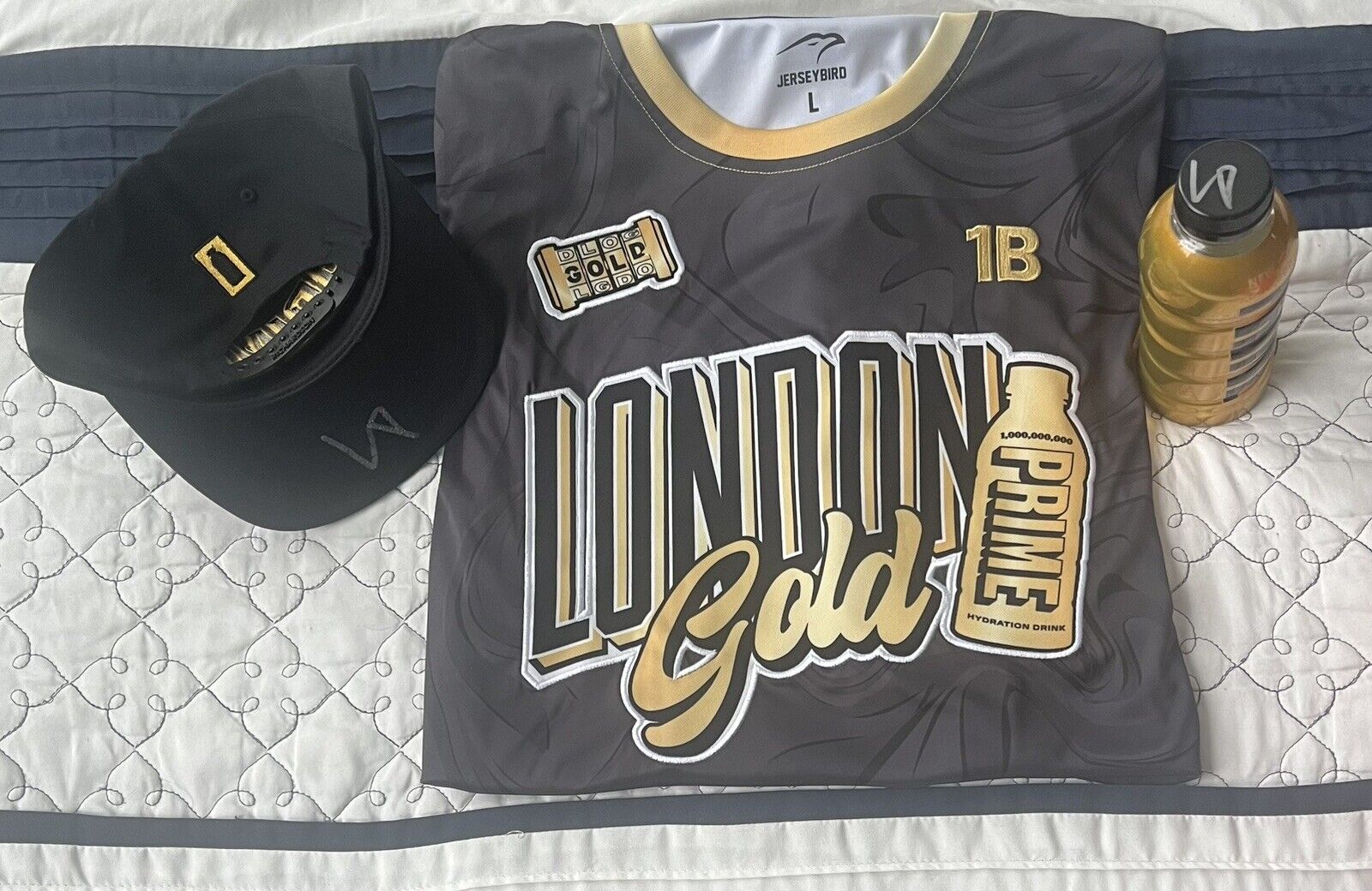 1 Signed Gold Prime Bottle, 1 Signed Prime Hat London Prime Jersey By Logan Paul